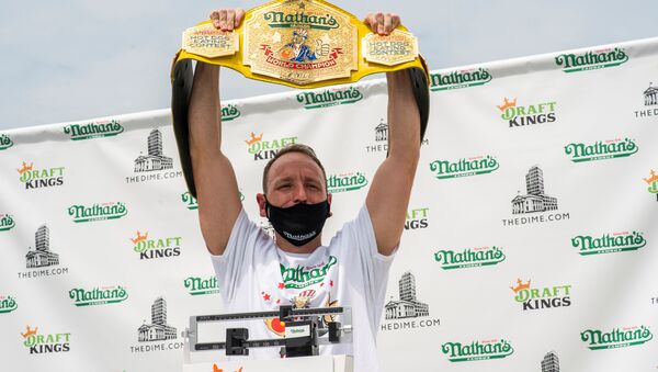 Current world record holder Joey Chestnut carries his belt as he poses during the official weigh-in ceremony for the Nathan's Famous Fourth of July International Hot Dog Eating Contest, in New York, U.S., July 3, 2020. - Sputnik International