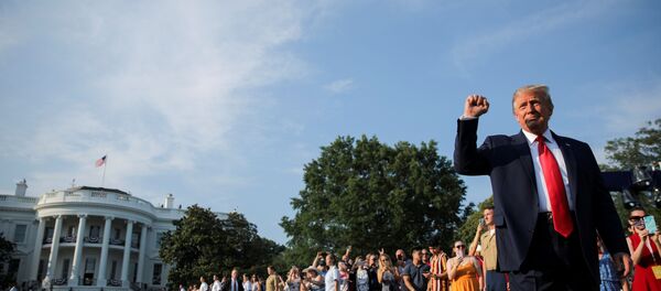 U.S. President Donald Trump thrusts his fist as he arrives on the White House South Lawn to host a 4th of July 2020 Salute to America to celebrate the U.S. Independence Day holiday at the White House in Washington, U.S., July 4, 2020 - Sputnik International
