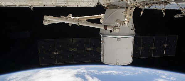 This NASA photo obtained March 10, 2020 shows the SpaceX Dragon resupply ship attached to the International Space Station's (ISS) Harmony module as both spacecraft were soaring 265 miles above the Atlantic coast of Brazil on March 9, 2020. - Sputnik International