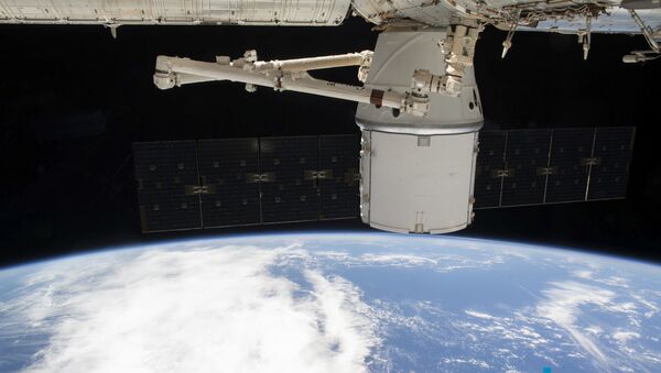 This NASA photo obtained March 10, 2020 shows the SpaceX Dragon resupply ship attached to the International Space Station's (ISS) Harmony module as both spacecraft were soaring 265 miles above the Atlantic coast of Brazil on March 9, 2020. - Sputnik International