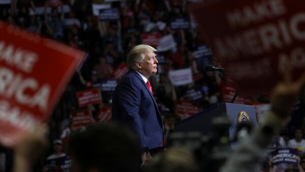 U.S. President Donald Trump stands at the podium listening to his supporters cheer as he addresses his first re-election campaign rally in several months in the midst of the coronavirus disease (COVID-19) outbreak, at the BOK Center in Tulsa, Oklahoma, U.S., June 20, 2020. - Sputnik International
