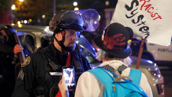 A police officer confronts a protester rallying against the death in Minneapolis police custody of George Floyd, in Portland, Oregon, U.S. June 13, 2020. Picture taken June 13. - Sputnik International