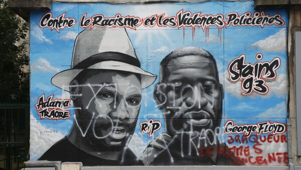 A photograph taken on July 5, 2020 shows a vandalised graffiti created by a French artist collective Collectif Art reading Against racism and police violence and paying tribute to George Floyd (R), an African american killed by a police officer in Minneapolis on May 25, 2020 and Adama Traore (L) a black man who died in police custody in 2016, on a wall in a street of Stains, in the outskirts of Paris. - The graffiti in memory of George Floyd and Adama Traore has been vandelised overnight on July 5, 2020 said a source from the prefecture. - Sputnik International