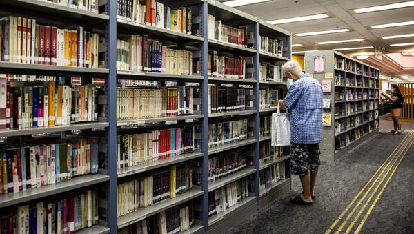 A man looks at books in a public library in Hong Kong on July 4, 2020. - Sputnik International