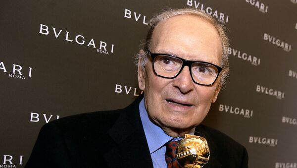 In this file photo taken on January 30, 2016 Italian composer Ennio Morricone poses with the 2016 Golden Globe for Best Original Score for Quentin Tarantino’s hit movie The Hateful Eight during a press conference at Bulgari Domus in central Rome on January 30, 2016. - Sputnik International