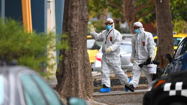 People in hazardous material overalls are seen outside of a public housing tower along Racecourse Road that was placed under lockdown due to the coronavirus disease (COVID-19) outbreak in Melbourne, Australia, July 6, 2020. - Sputnik International