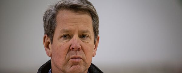 Georgia Gov. Brian Kemp listens to a question from the press during a tour of a massive temporary hospital at the Georgia World Congress Center on Thursday, April 16, 2020, in Atlanta. Kemp took part in a tour of the 200-bed facility, constructed quickly in the lower levels of the Georgia World Congress Center which normally plays host to large conventions and sporting events. - Sputnik International