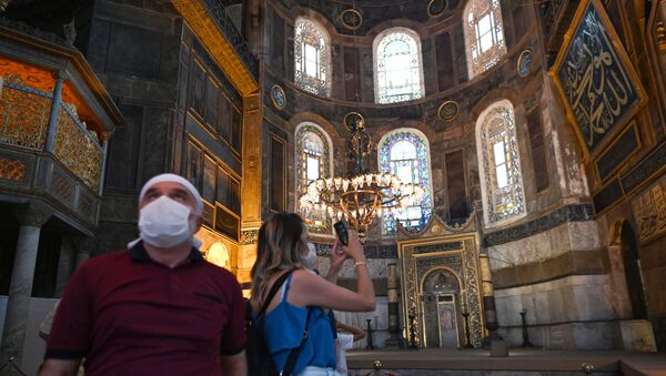 A woman takes a picture with mobile phone inside the Hagia Sophia museum in Istanbul, on July 2, 2020. - Turkey's top court considered whether Istanbul's emblematic landmark and former cathedral Hagia Sophia can be redesignated as a mosque, a ruling which could inflame tensions with the West. - Sputnik International