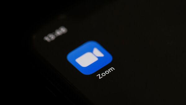 This illustration picture taken on May 27, 2020 in Paris shows the logo of the social network  application Zoom on the screen of a phone. - Sputnik International