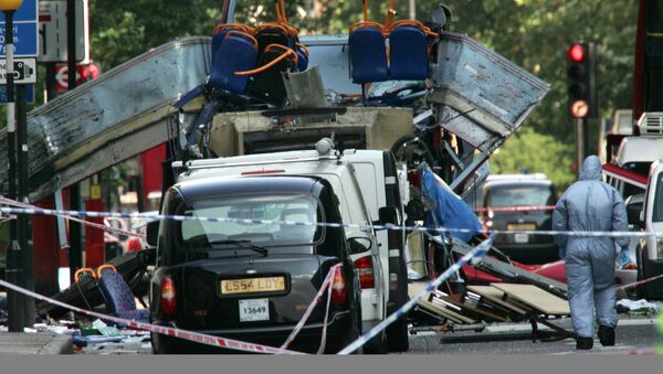 FILE - This is a Thursday, July 7, 2005, file photo of  forensic officer as he walks next to the wreckage of a double decker bus with its top blown off and damaged cars scattered on the road at Tavistock Square in central London - Sputnik International