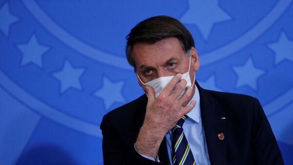 Brazil's President Jair Bolsonaro adjusts his protective face mask during the inauguration ceremony of the new Communications Minister Fabio Faria (not pictured) at the Planalto Palace in Brasilia, Brazil, 17 June 2020 - Sputnik International