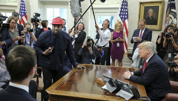 Rapper Kanye West, second left, stands up as he speaks during a meeting with US President Donald Trump in the Oval office of the White House on 11 October 2018 in Washington, DC.  - Sputnik International