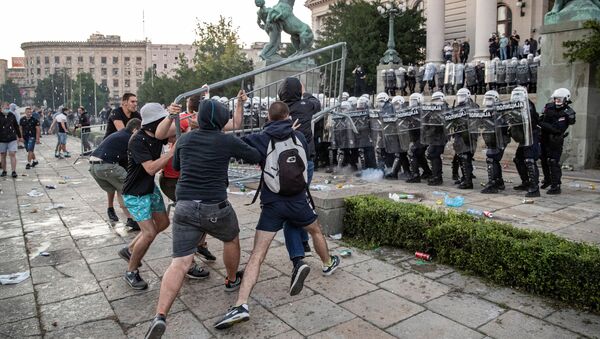 Demonstrators clash with police officers during an anti-government rally, amid the spread of the coronavirus disease (COVID-19), in front of the parliament building in Belgrade, Serbia, July 8, 2020 - Sputnik International