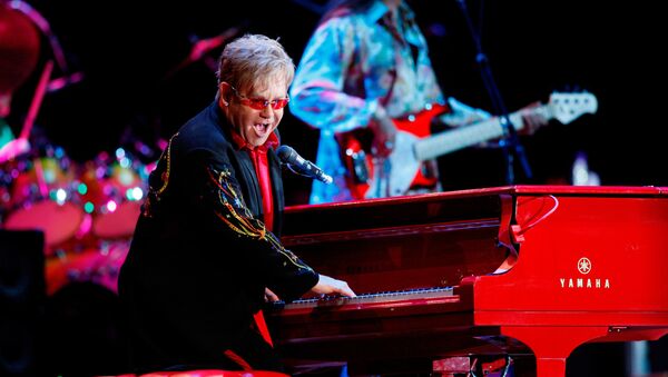Sir Elton John has praised Pope Francis as his hero, recommending the Argentinian pontiff for sancthood. Archive photo of one of Sir Elton's performances, alongside his famous red Yamaha piano. - Sputnik International