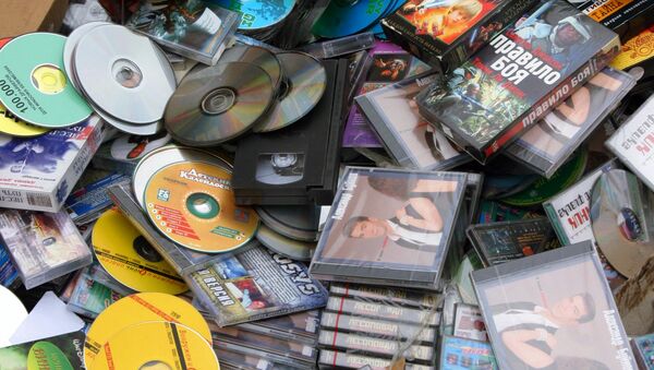 Bulldozing heaped counterfeit products, CD and DVD disks - Sputnik International