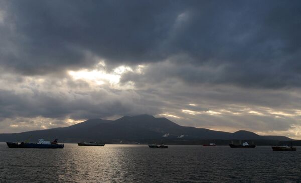 Kunashir Island, Kuril Islands. Russian fishing vessels in the foreground Kunashir Island, Kuril Islands. Russian fishing vessels in the foreground - Sputnik International