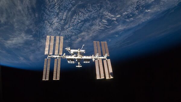 The International Space Station hovers above the Earth. - Sputnik International