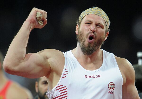 Poland's Tomasz Majewski retained his Olympic shot put title on Friday, snatching gold by just three centimeters with a throw of 21.89 meters - Sputnik International