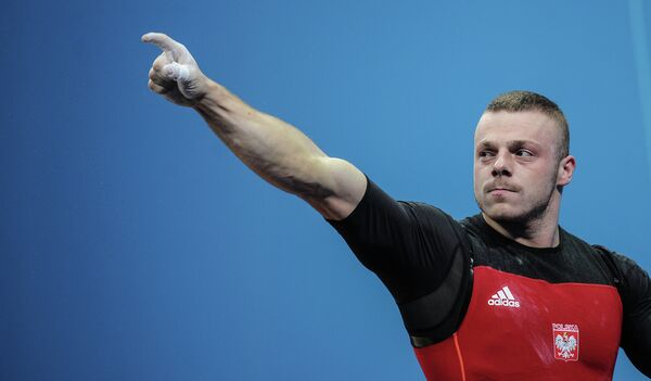 Adrian Zielinski of Poland claimed weightlifting gold by the narrowest possible margin in the men's 85kg category on Friday - Sputnik International