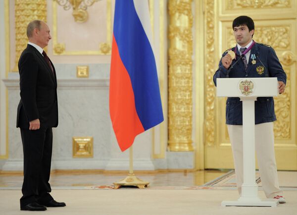 Vladimir Putin (left) and judo champion Tagir Khaibulaev - Sputnik International