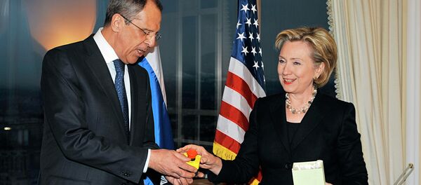 U.S. Secretary of State Hillary Clinton gives Russian Foreign Minister Sergei Lavrov the block with a red button marked reset in English and overload in Russian during a meeting in Geneva on March 6, 2009 U.S. Secretary of State Hillary Clinton gives Russian Foreign Minister Sergei Lavrov the block with a red button marked reset in English and overload in Russian during a meeting in Geneva on March 6, 2009 - Sputnik International