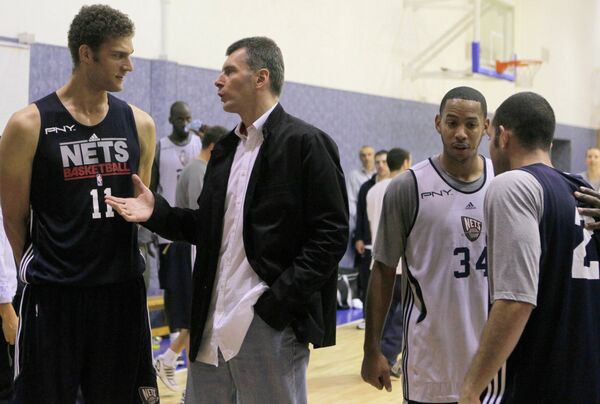 Russian billionaire Mikhail Prokhorov chats in Moscow in October 2010 with players from his basketball team, then still called the New Jersey Nets. Archive - Sputnik International