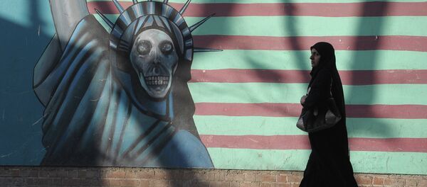 A woman walking past the outer wall of the former US embassy in Tehran, which was seized by Islamists in 1980 - Sputnik International