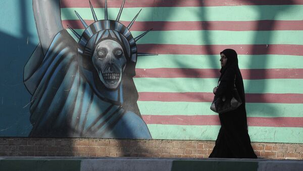 A woman walking past the outer wall of the former US embassy in Tehran, which was seized by Islamists in 1980 - Sputnik International