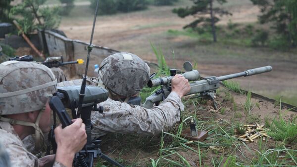 A US Marine takes aim at a long range target at the live fire range on Base Camp Adazi, Latvia on June 15, 2012 - Sputnik International