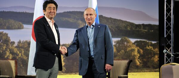 Japanese Prime Minister Shinzo Abe and Russian President Vladimir Putin shake hands before their meeting during the G8 Summit at Lough Erne in Enniskillen, Northern Ireland, June 17, 2013 Japanese Prime Minister Shinzo Abe and Russian President Vladimir Putin shake hands before their meeting during the G8 Summit at Lough Erne in Enniskillen, Northern Ireland, June 17, 2013 - Sputnik International