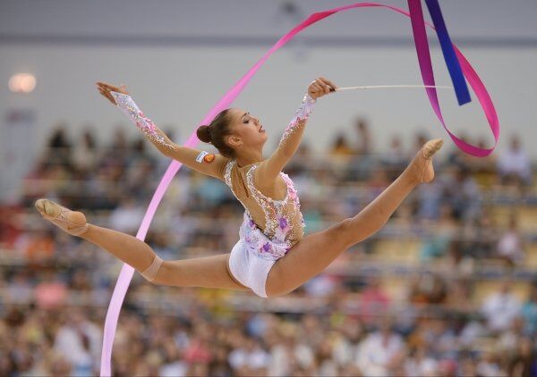 A rhythmic gymnast performs the ribbon routine during competitions in Kazan, Russia, on July 16. - Sputnik International