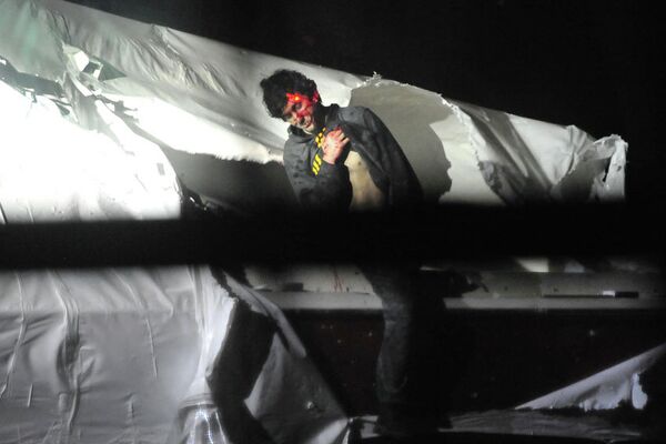 Boston bombing suspect Dzhokhar Tsarnaev emerges from the boat where he was captured on April 19. - Sputnik International