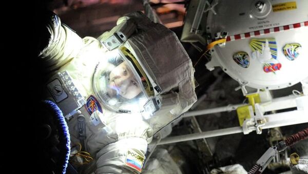 Russian cosmonaut Alexander Misurkin conducts a check of his spacesuit, “Orlan-MK,” before his Friday spacewalk. - Sputnik International