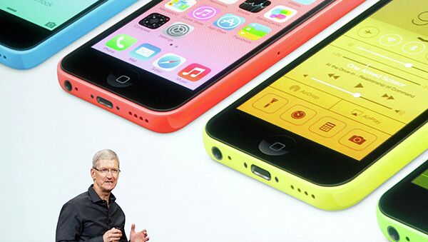 Apple CEO Tim Cook talks about the colorful new iPhones in Cupertino, California, Tuesday. - Sputnik International