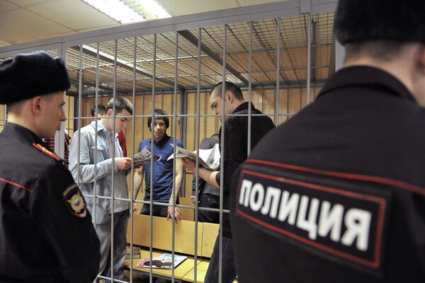 Bolotnaya prisoners Denis Lutskevich, Andrey Barabanov and Stepan Zimin (from L-R) in court, Nov. 25, 2013 - Sputnik International