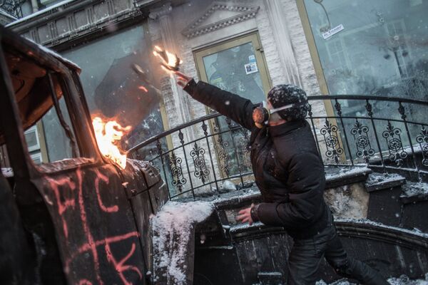 A pro-European integration protester throws a Molotov cocktail on Grushevskogo Street in Kiev. - Sputnik International