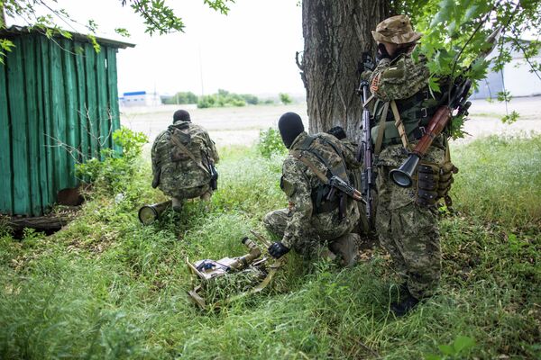 Donbass people's volunteer corps members during military operations on the outskirts of Slavyansk Donbass people's volunteer corps members during military operations on the outskirts of Slavyansk - Sputnik International