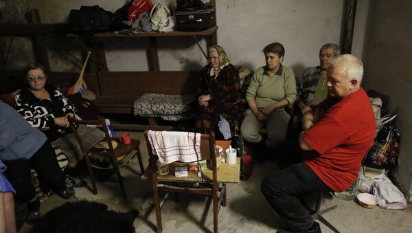 Residents of the city of Yasinovataya, hiding from the shelling in the basement of their house - Sputnik International