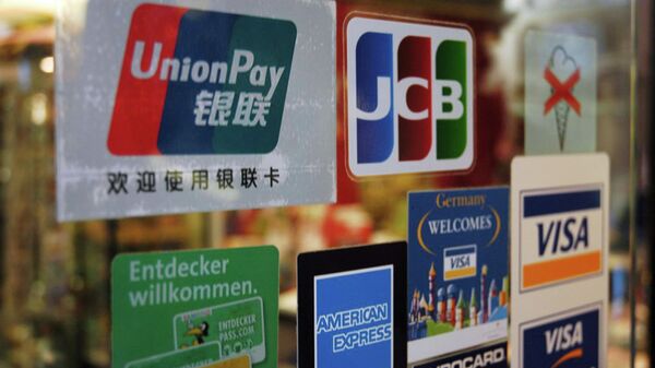 UnionPay, Visa and other payment card logos on the glass of a shop in Germany. File photo. - Sputnik International