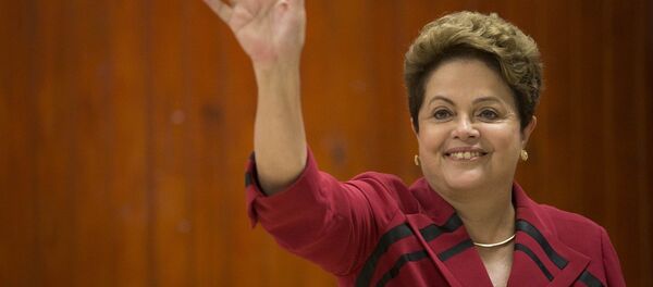 Brazil's President Dilma Rousseff, who is running for re-election with the Workers Party (PT), waves after voting in general elections in Porto Alegre, Brazil, early Sunday, Oct. 5, 2014. Brazil's President Dilma Rousseff, who is running for re-election with the Workers Party (PT), waves after voting in general elections in Porto Alegre, Brazil, early Sunday, Oct. 5, 2014. - Sputnik International